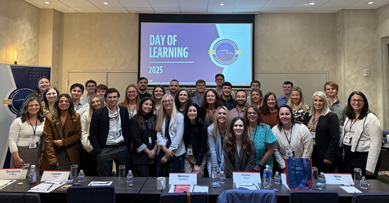 group of young professionals posing for picture