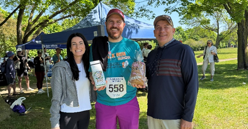 3 individuals standing together after a race