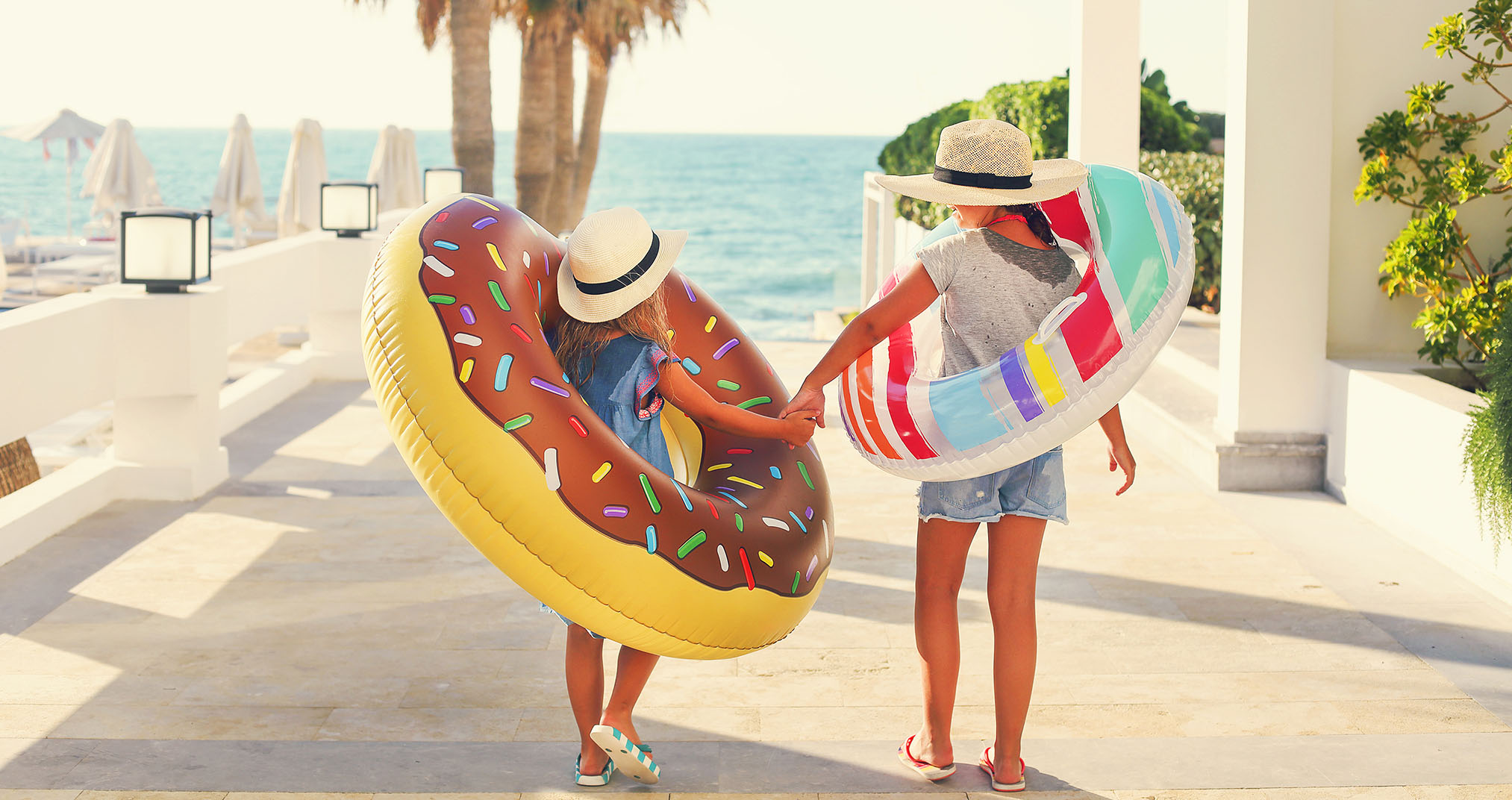 Image of two children walking to the beach