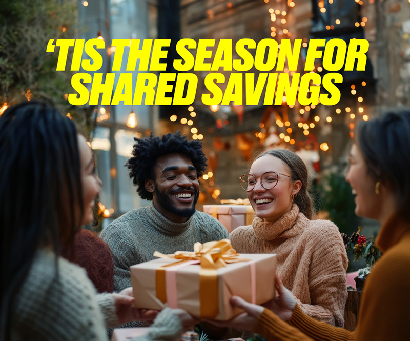 A group of friends huddling around a wrapped present with yellow text above that reads 'Tis the season for shared savings