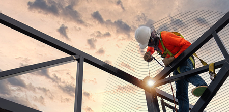 Construction worker onsite welding steel structure