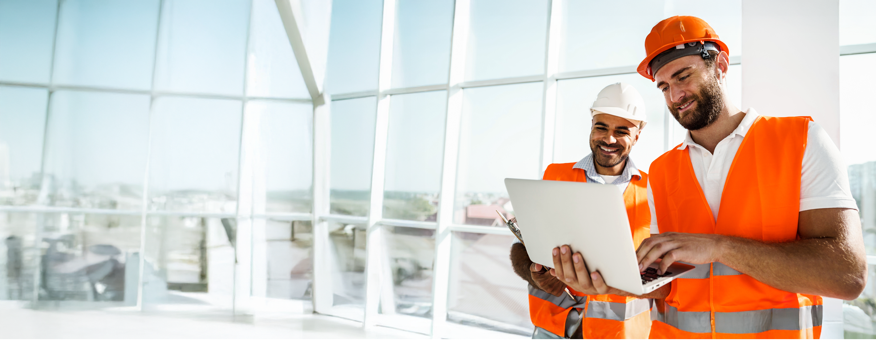 Construction managers collaborate onsite using digital tools for project tracking and planning