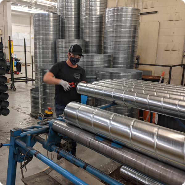 A worker in a mask works in a warehouse.
