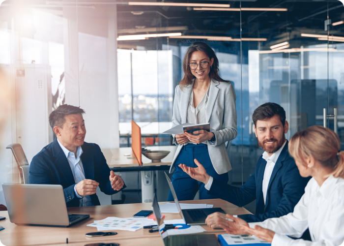 Four executives have a meeting in a conference room.
