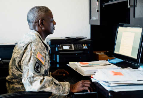 Confident businesswoman working on her laptop in an office setting.