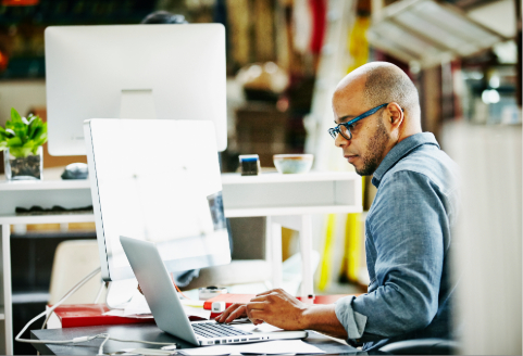Two co-workers viewing a computer screen.