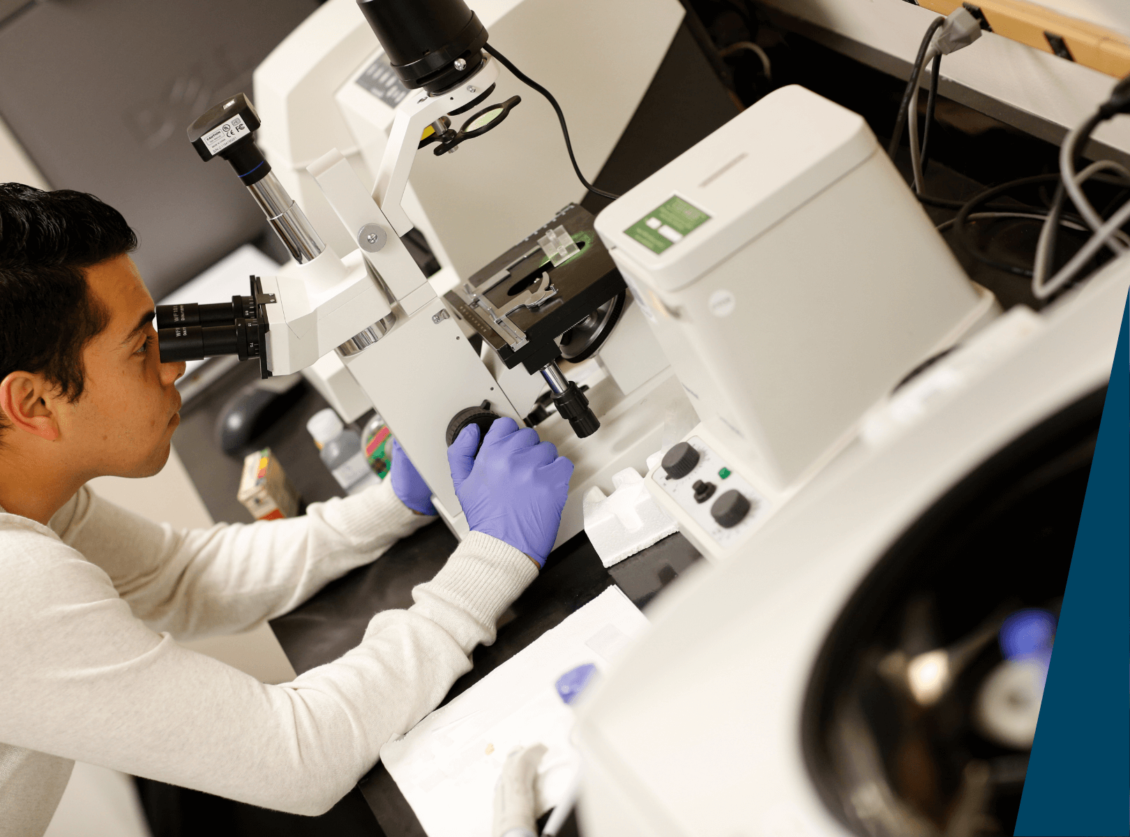 Student using microscope.