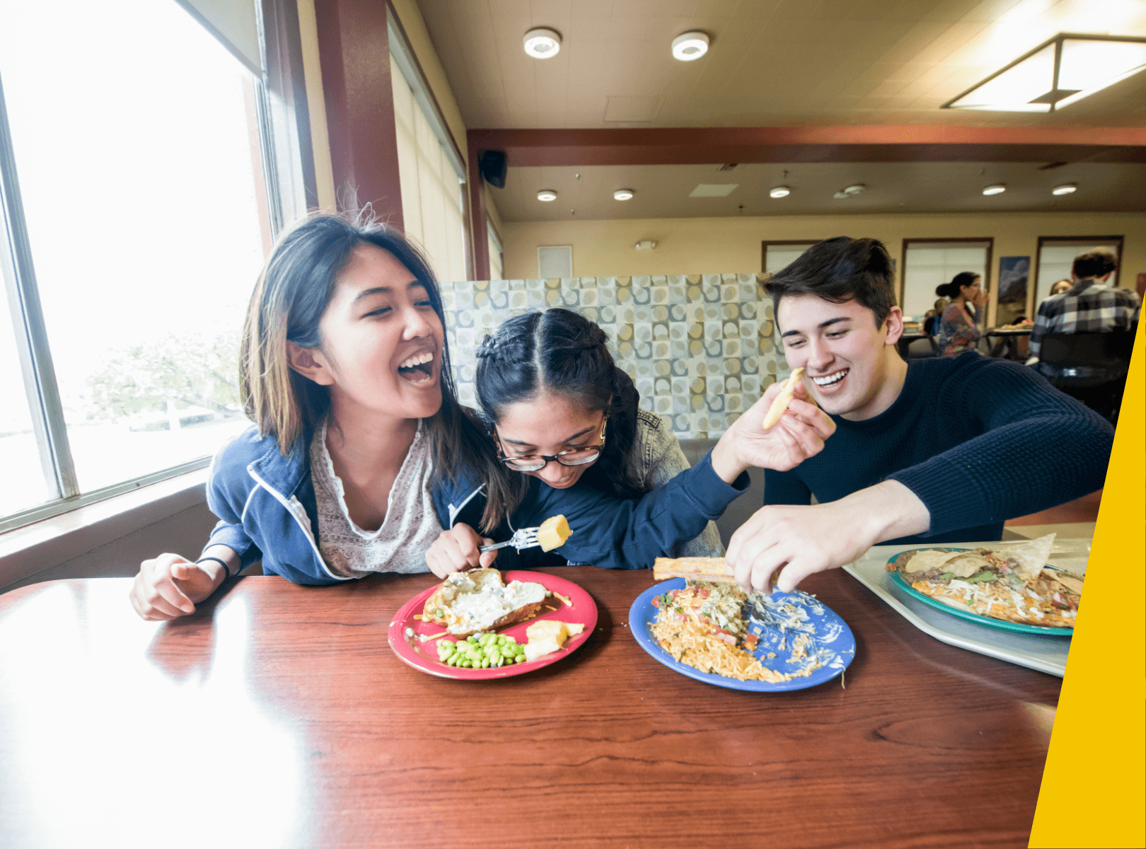 Students eating in dining hall.