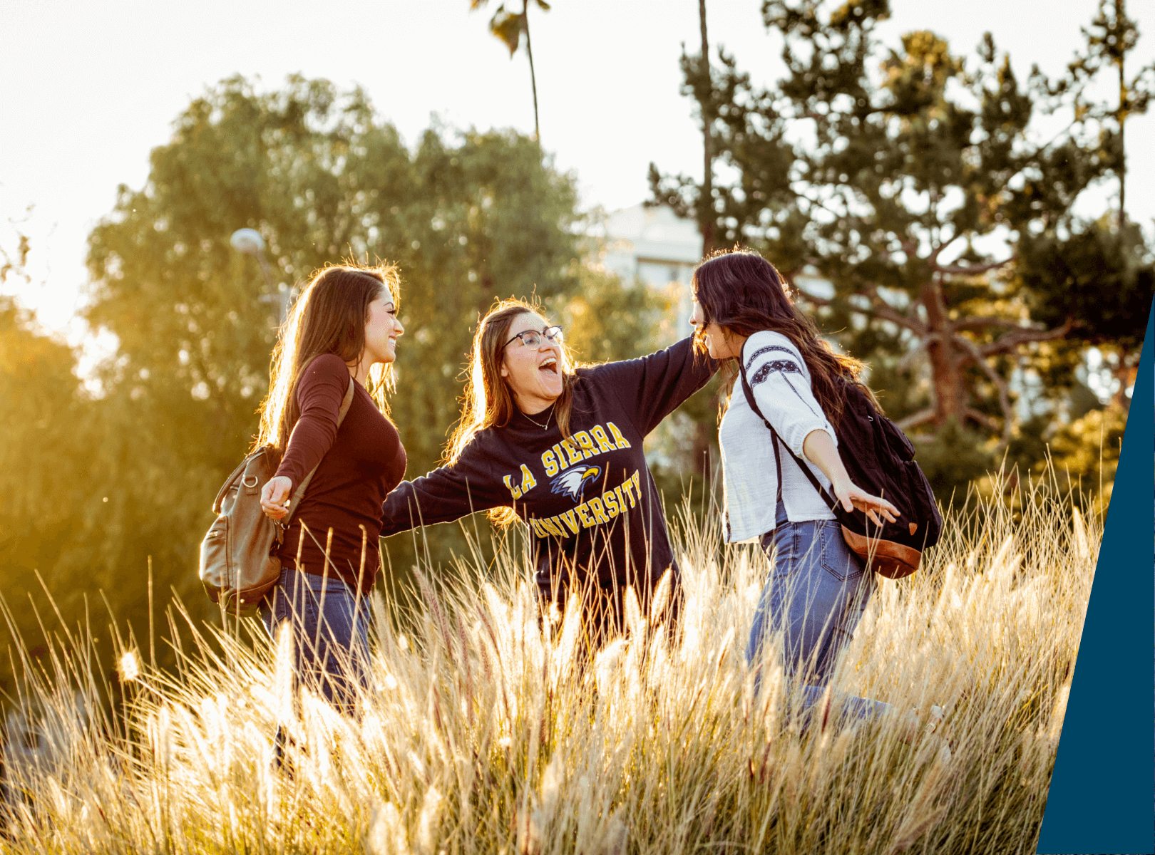 Students outside laughing and smiling.