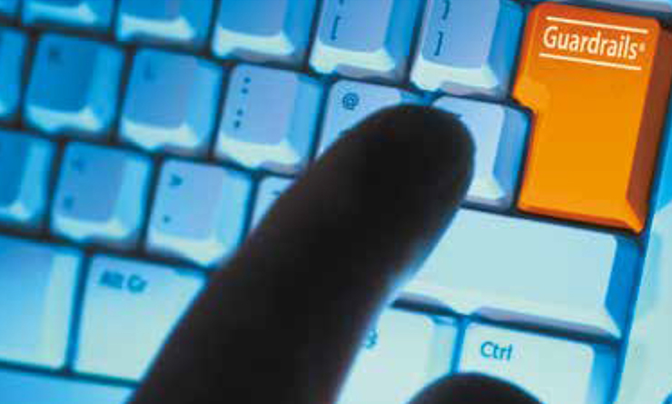 Finger over computer keyboard highlighting key with name 'Guardrails'