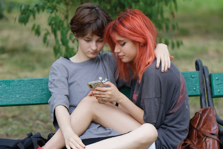 Two teens on cell phone
