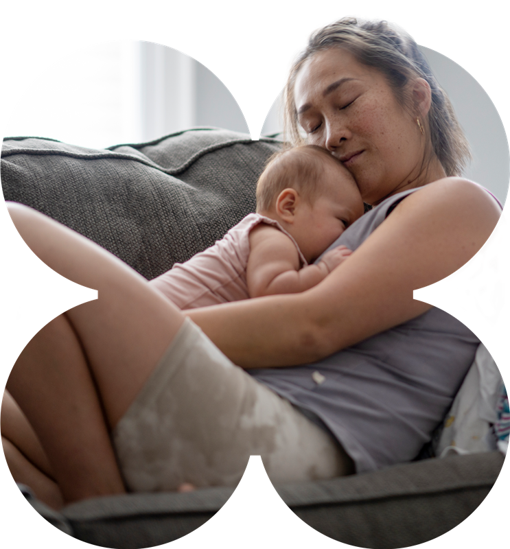 woman holding onto baby