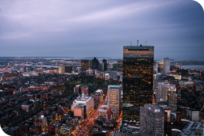 A woman is sitting at a desk using a tablet