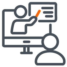 A woman sitting at a desk talking on a cell phone in front of a laptop