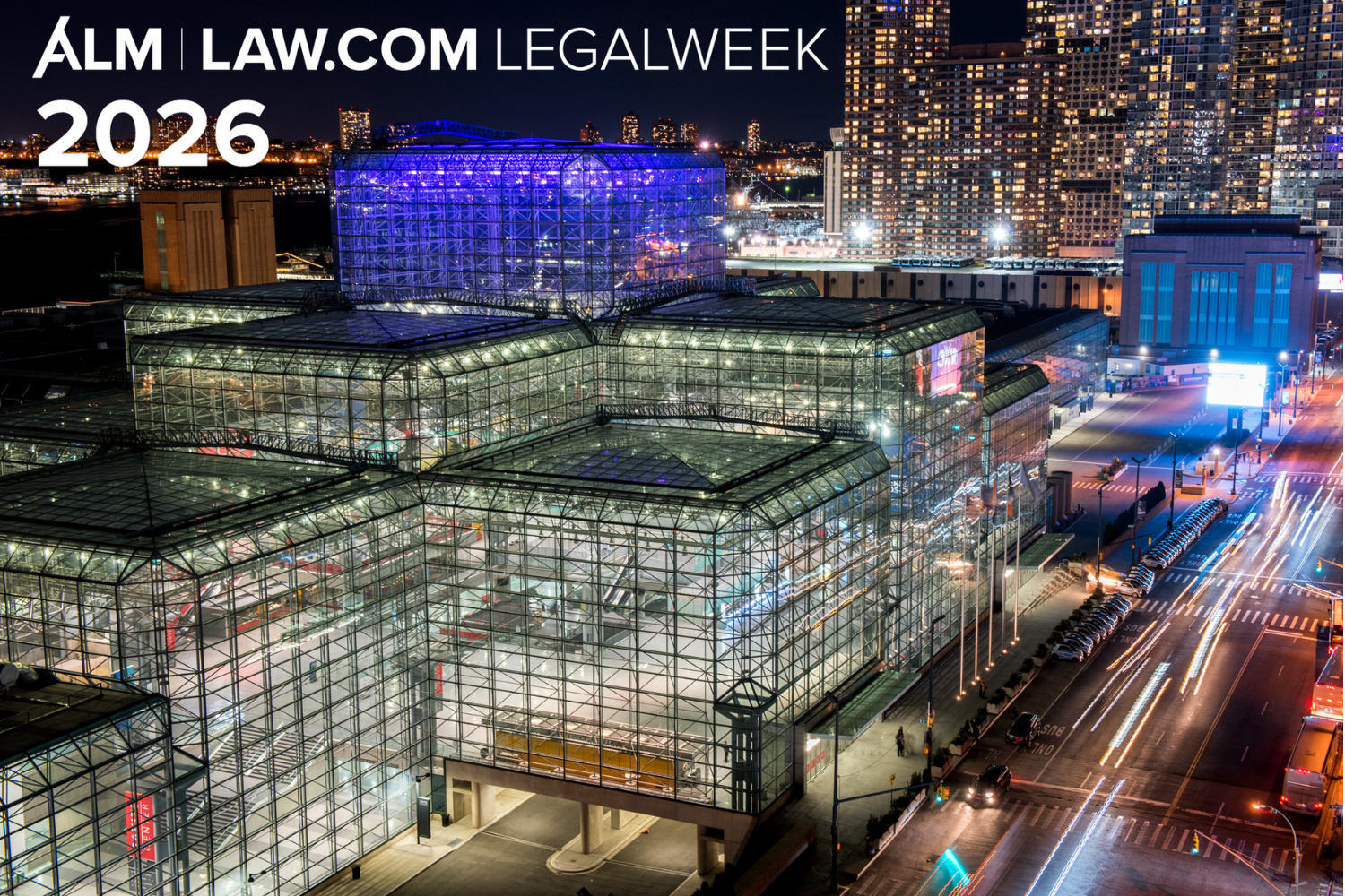 A woman is sitting at a desk using a tablet