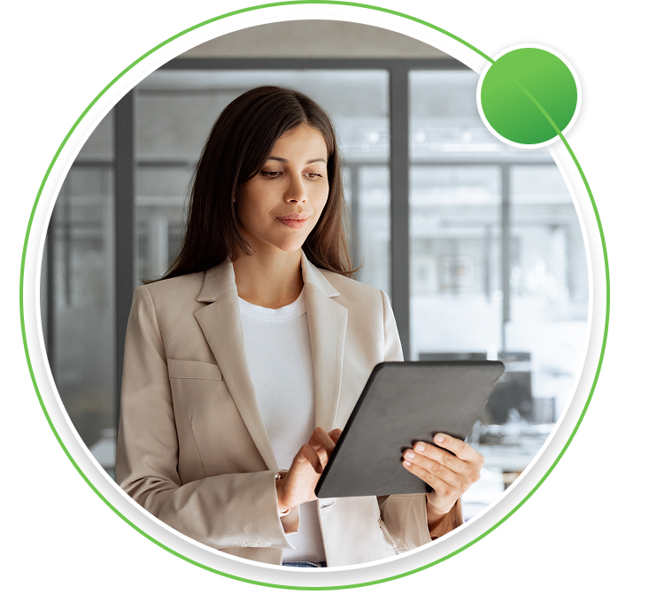 Three professionals in a modern office meeting room, with a man leading a discussion in front of a glass board displaying business charts.