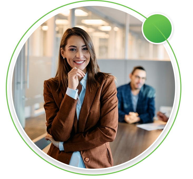 Three professionals in a modern office meeting room, with a man leading a discussion in front of a glass board displaying business charts.