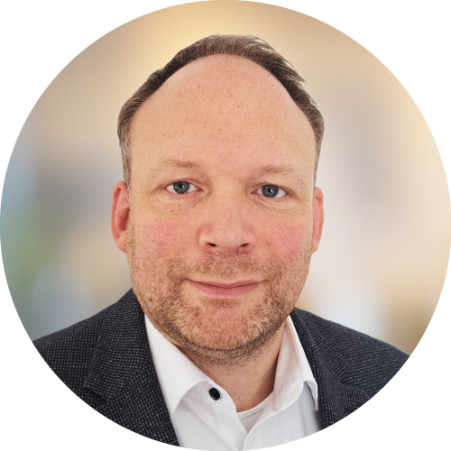 Headshot of a man in a suit and tie.