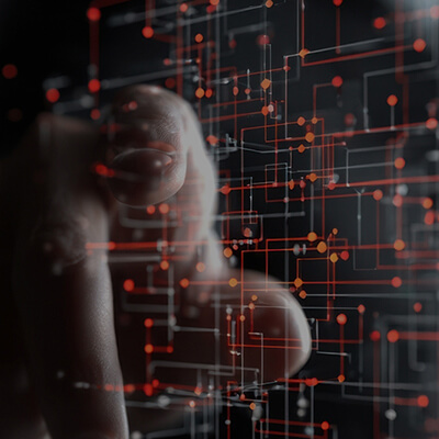 A hand interacting with a futuristic digital interface showing a network of red and orange lines and glowing dots.