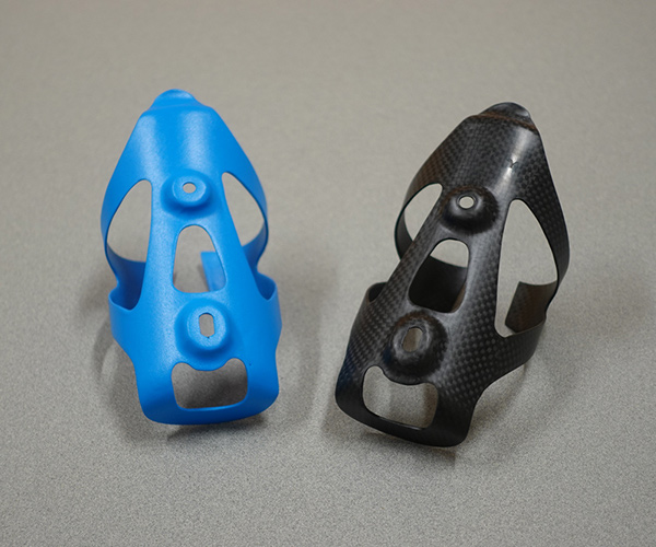 One blue bicycle water bottle cage and one black one.
