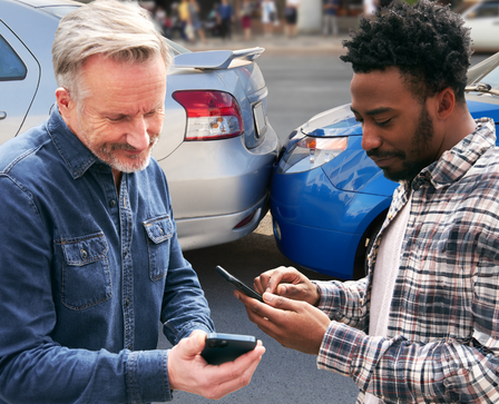 Community members exchanging driver information at accident scene