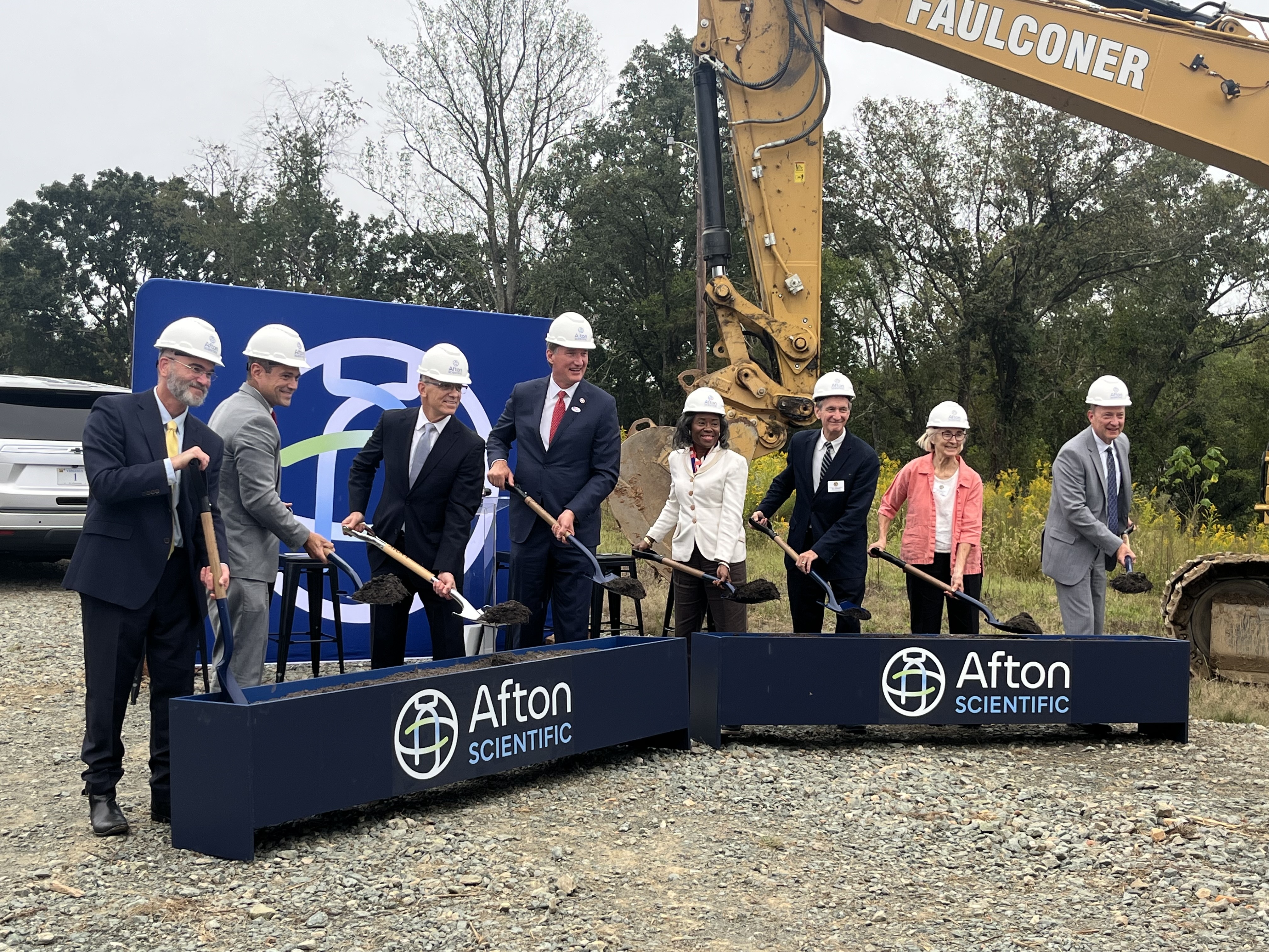 A modern cleanroom featuring an automated Groninger + Skan manufacturing line with glass enclosures, white gloves, and a system for conveying small containers.